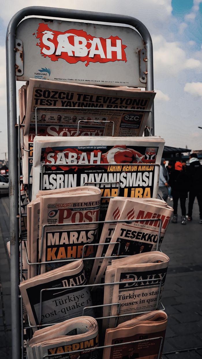 about-01 Outdoor display of Turkish newspapers with headlines in focus.